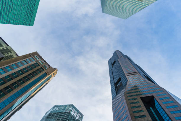 istock Bottom view of modern skyscrapers in business district against sky 806897792