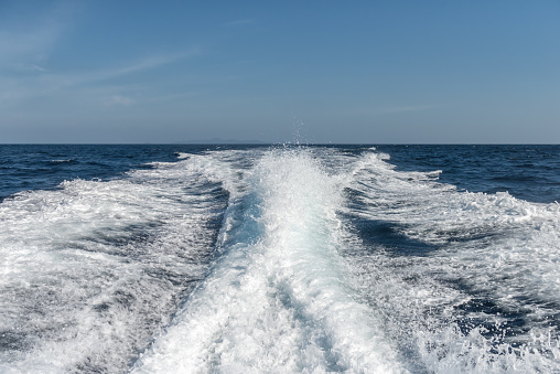 Water surface behind of fast moving motor boat