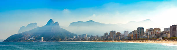 Panoramic image of Arpoador, Ipanema and Leblon beaches in Rio de Janeiro Panoramic landscape of the beaches of Arpoador, Ipanema and Leblon in Rio de Janeiro with sky and the hill Two brothers, Vidigal, and Gávea stone in the background two brothers mountain stock pictures, royalty-free photos & images