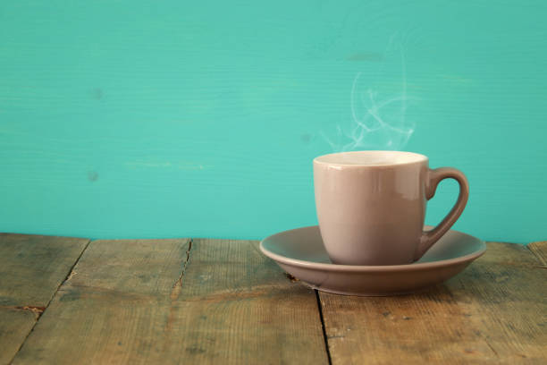 istock Image of coffe cup on wooden table 806901204