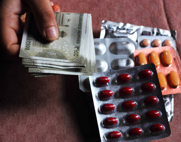 Some unknown person buying medicines at a medical store and paying Indian currency notes