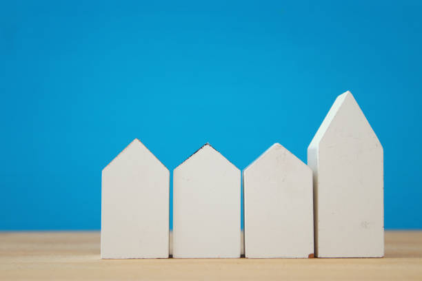 istock small house model over wooden floor. selective focus 806904024