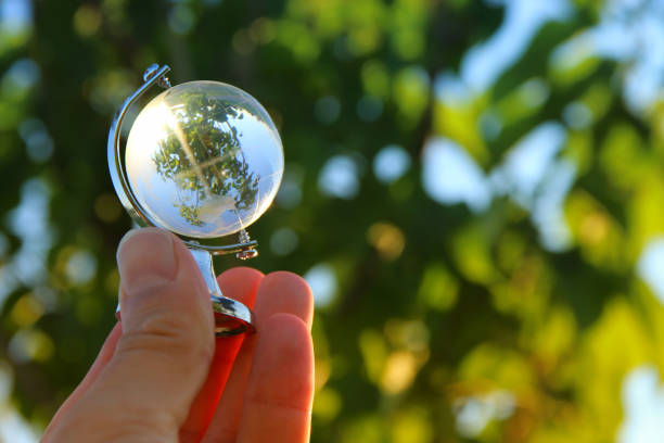 istock male hand holding small crystal globe 806904064