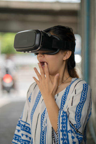 istock Asian woman getting experience using VR-headset glasses of virtual reality. 806904732