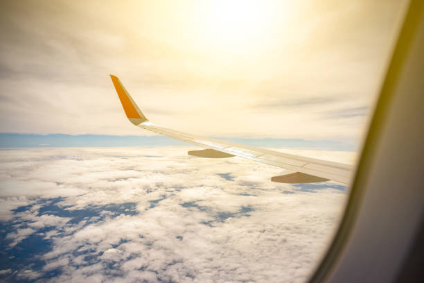 istock Wing of a Airplane above clouds 806907258