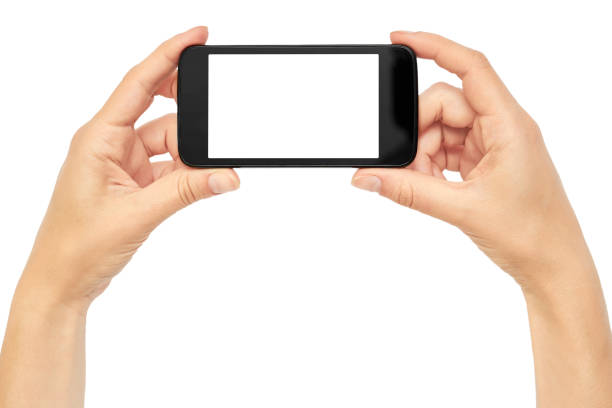 istock Female hands hold a cell phone, mockup template. Isolated on white background 806907318