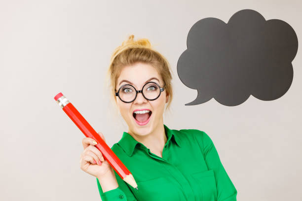 istock Woman holding big oversized pencil thinking 806907348