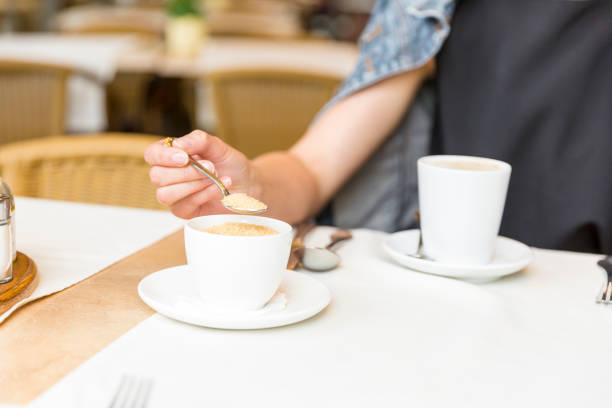 istock Beautiful young girl resting in a cafe, adding sugar into coffee 806911626