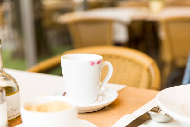 istock Red lipstick on coffee mug in restaurant 806911742