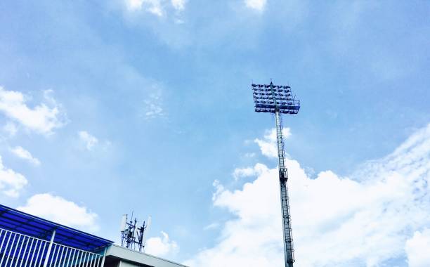 istock Spotlights in Stadium Againt Blue Sky Background 806914962
