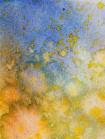 An hand painted watercolor background. The prominent colors are shades of yellow and blue. There is a mottled texture with paint splatters throughout.