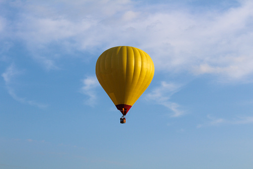 Yellow hot air balloon on blue sky