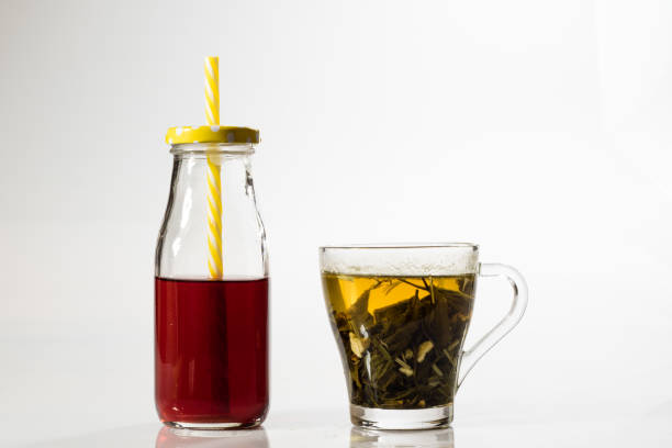 Tea in a glass on a white background. Green or fruit tea. Glass of white glass