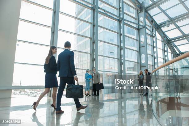 Business People Walking In Glass Building Stock Photo - Download Image Now - Business, Walking, Business Person