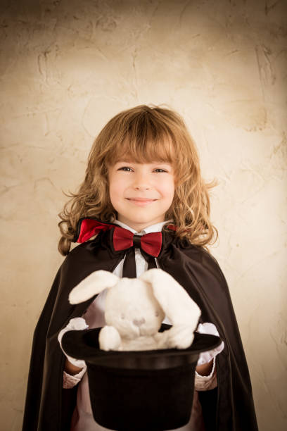 istock Magician holding a top hat with a toy rabbit 806985808