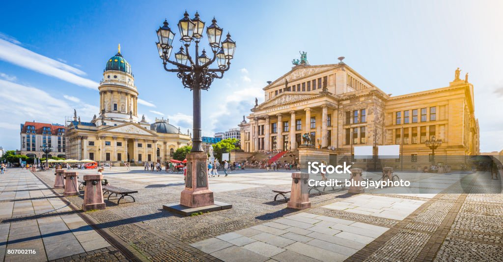 Berlin Gendarmenmarkt square at sunset, central Berlin Mitte district, Germany Panoramic view of famous Gendarmenmarkt square with Berlin Concert Hall and German Cathedral in golden evening light at sunset with blue sky and clouds in summer, Berlin Mitte district, Germany Berlin Stock Photo