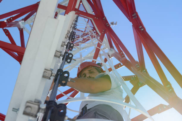 istock Man is climbing a high power electric line tower 807010178