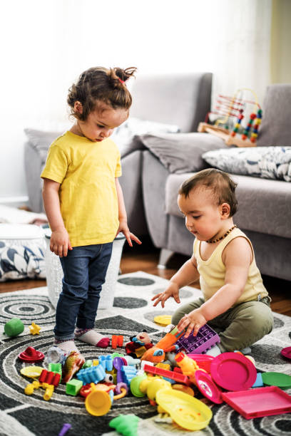 istock Cute babies playing with toys 807023086