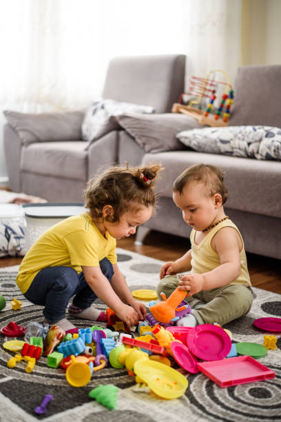 istock Cute babies playing with toys 807025190