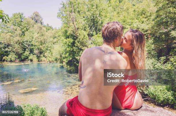 Happy Young Couple Enjoys An Island In Nature Stock Photo - Download Image Now - Couple - Relationship, Falling in Love, Kissing