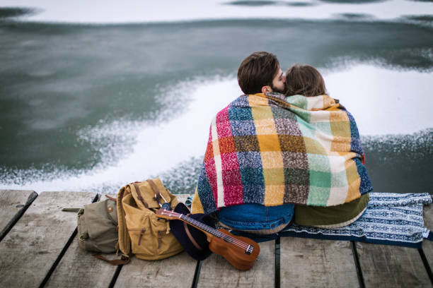 istock Romantic Young couple hugging by the lake in winter 807030520