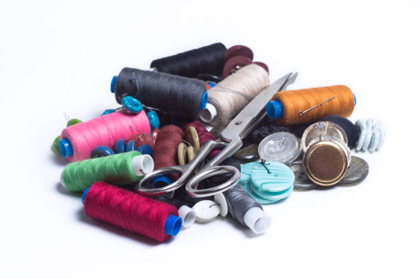 istock Colored spools of thread, buttons and scissors are a bunch on white background 807030728