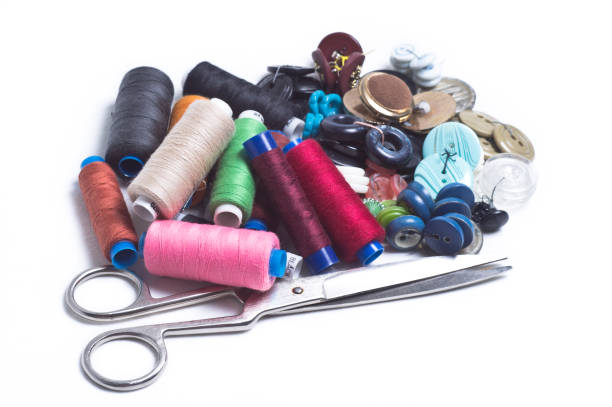 istock Colored spools of thread, buttons and scissors are a bunch on white background 807030816