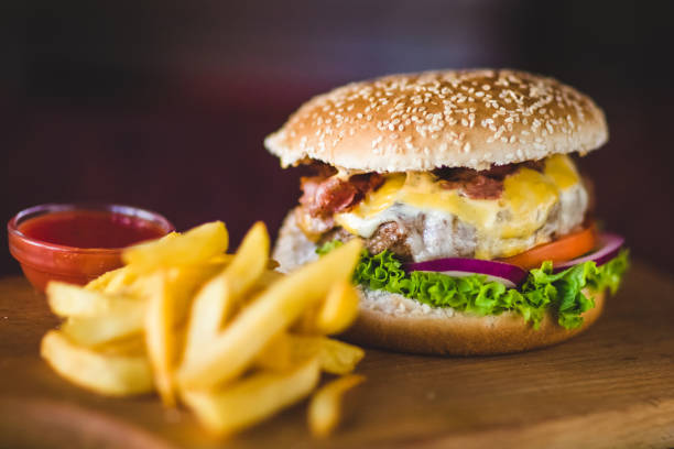 istock Cheeseburger and fries on restaurant table 807030918