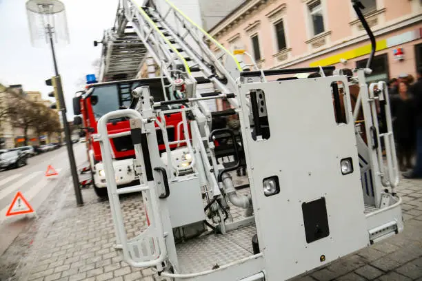 Firetruck on a city street, close-up view of ladder lift.