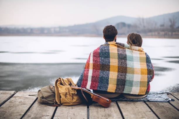 istock Romantic Young couple hugging by the lake in winter 807039450