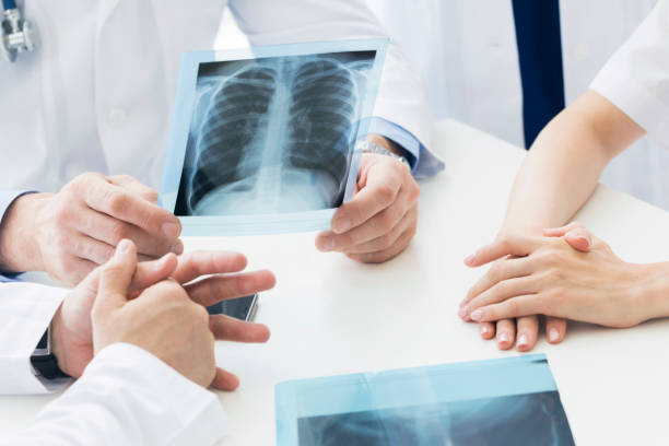 istock Group of doctors discuss x-ray 807042144