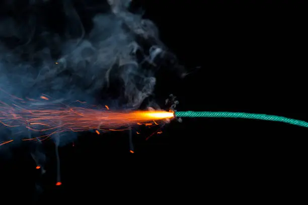 Photo of Fuse burning on black background isolated