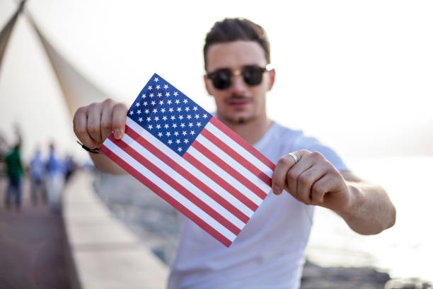 istock Attractive young man showing flag at 4 th July 807058036
