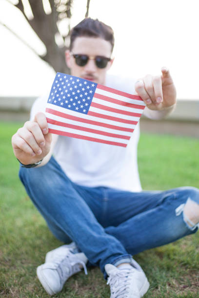 istock Young man holding flag at 4 th July 807058094