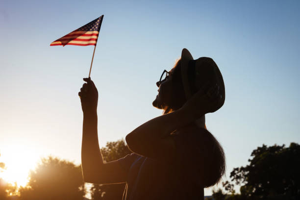 istock Woman holding USA flag 807078528