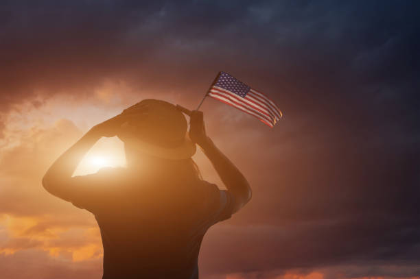 istock Woman holding USA flag 807078566