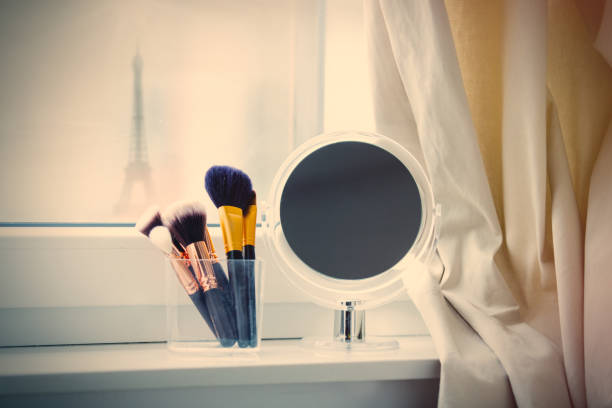 istock professional makeup brushes in glassy box and cute mirror on the wonderful white windowsill 807095808