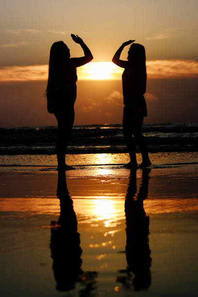 Silhouette of a mother and son in a ferry window at sunset