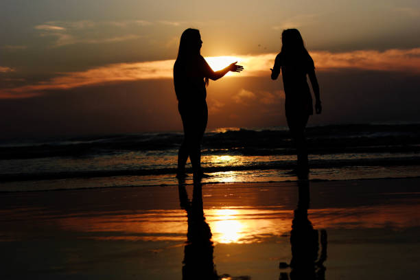 istock Women high five each other at the beach 807096608