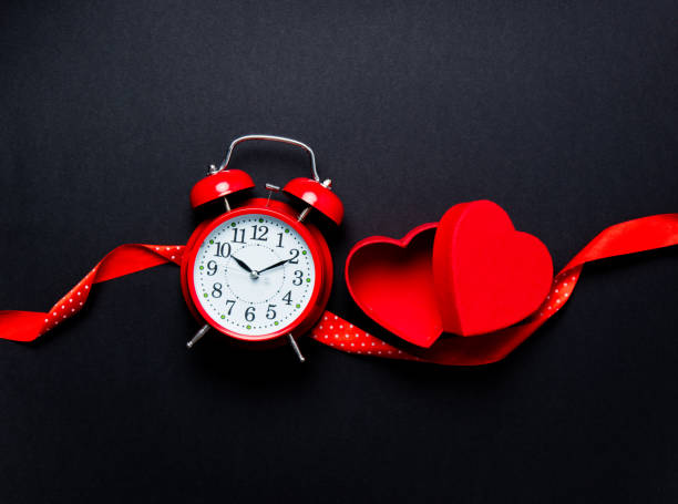 istock Alarm clock and heart shape toy 807104274