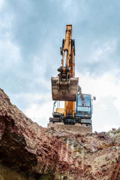 istock Excavator working on a construction site. The digging of the trench. 807140066