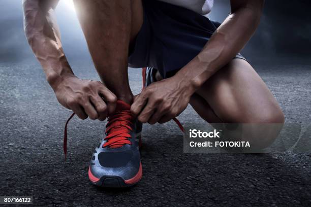 Man Tying Running Shoes Stock Photo - Download Image Now - Running, Beginnings, Shoe