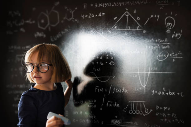 istock Little Girl Writing Blackboard Concept 807176300