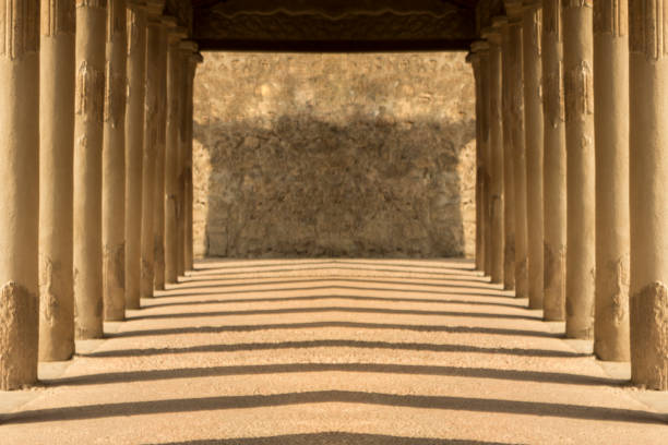 istock Ancient symmetrical hallway with evening shadows and brick work in Pompeii old city for tourism concept with copy space. 807188184