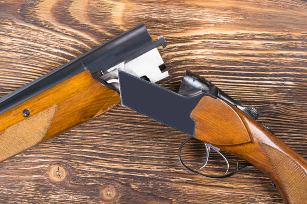 istock An open rifle with cartridges rests on a wooden table 807201926