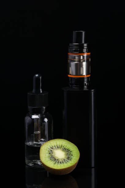 istock the concept of electronic cigarettes and kiwi on a dark background 807204966