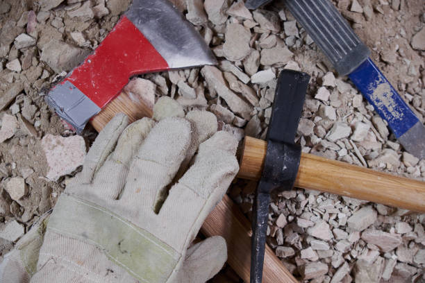 istock Axe, gloves and construction tools on pile of rubble 807205008