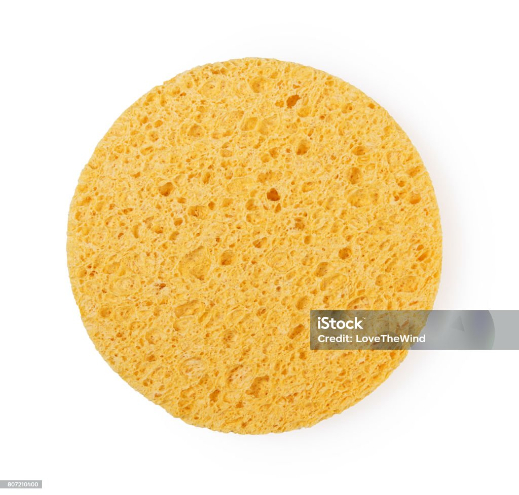 Yellow sponge circle shape cleansing puff for face or cleaning Cleaning Sponge Stock Photo