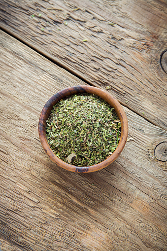 Mixed Italian Herbs Seasoning on wooden background, copy space. Dried Herbs Seasoning, healthy ingredient for cooking.