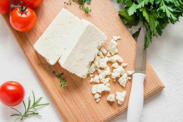 Greek Feta Cheese Fresh Greek Feta Cheese. Healthy ingredient for cooking salad. Crumbled Goat feta cheese on cutting board. white cheese stock pictures, royalty-free photos & images